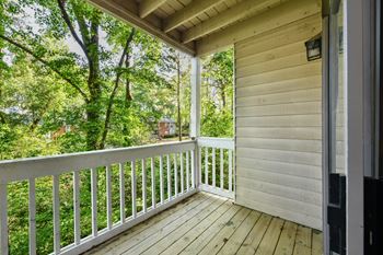 The view from the porch of a cabin with a porch swing